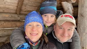 Jolene, her son, and husband hiking in winter gear in 2022