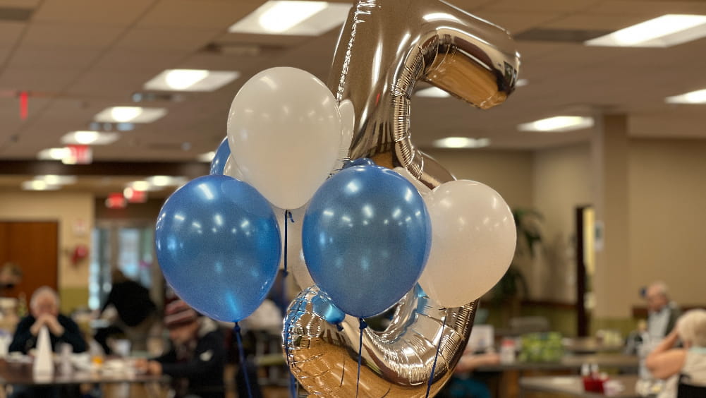 blue and white balloons with a silver number 5 balloon
