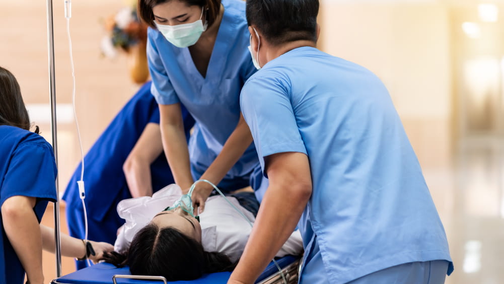 Two medical professionals performing CPR on a patient
